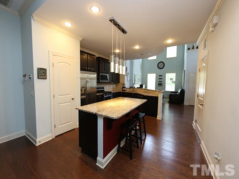 811 Chapanoke Road Raleigh, NC 27603 - Photo 7 of 25 a kitchen with stainless steel appliances granite countertop a refrigerator a stove a sink dishwasher and a refrigerator with wooden floor