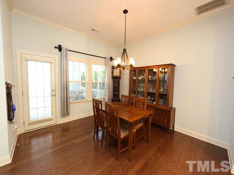 811 Chapanoke Road Raleigh, NC 27603 - Photo 8 of 25 a view of a dining room with furniture window and wooden floor