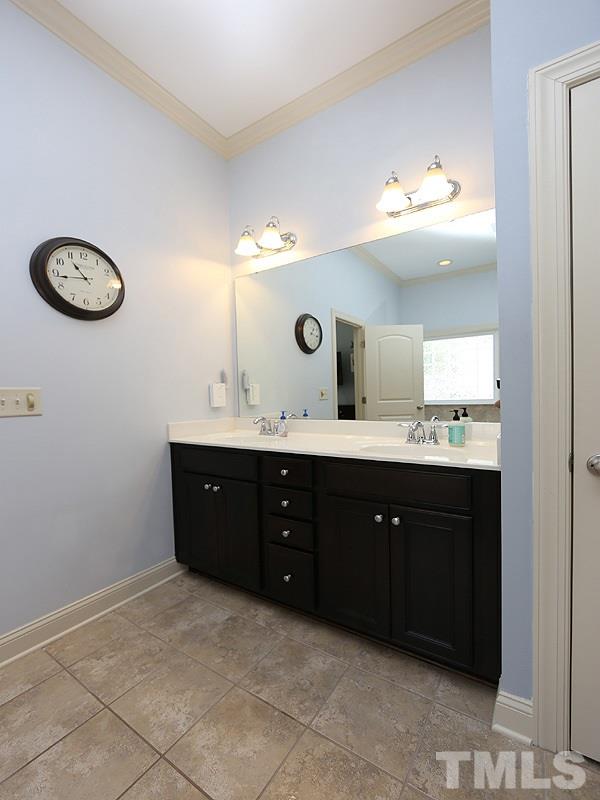 811 Chapanoke Road Raleigh, NC 27603 - Photo 10 of 25 a spacious bathroom with a double vanity and a mirror