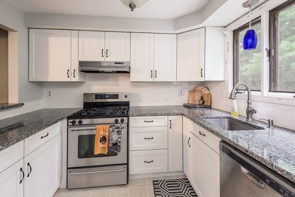 1 Spruce Tree Lane, Unit 3 Norton, MA 02766 - Photo 1 of 18 a kitchen with granite countertop white cabinets and white appliances