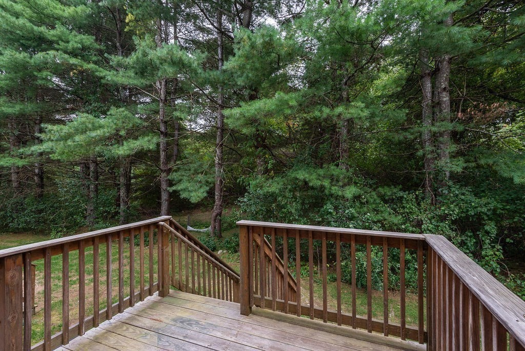 1 Spruce Tree Lane, Unit 3 Norton, MA 02766 - Photo 17 of 18 a view of a balcony with wooden floor and fence