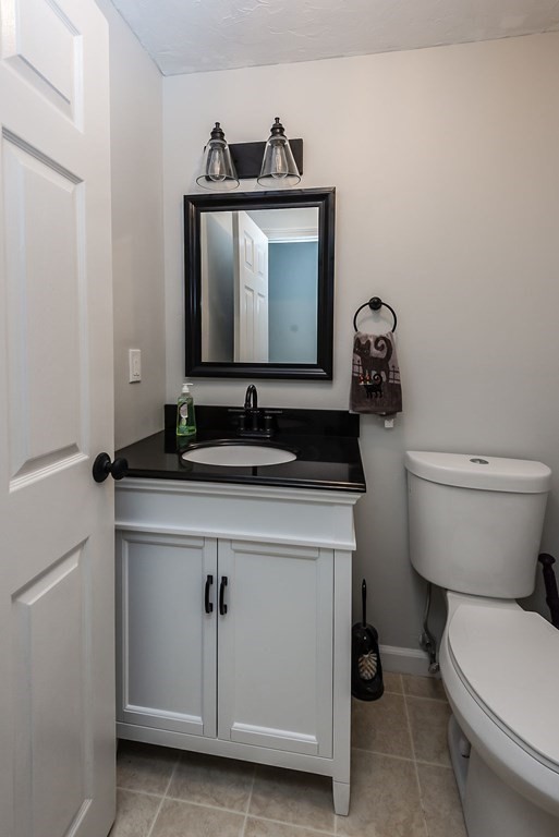 1 Spruce Tree Lane, Unit 3 Norton, MA 02766 - Photo 6 of 18 a bathroom with a toilet sink and mirror