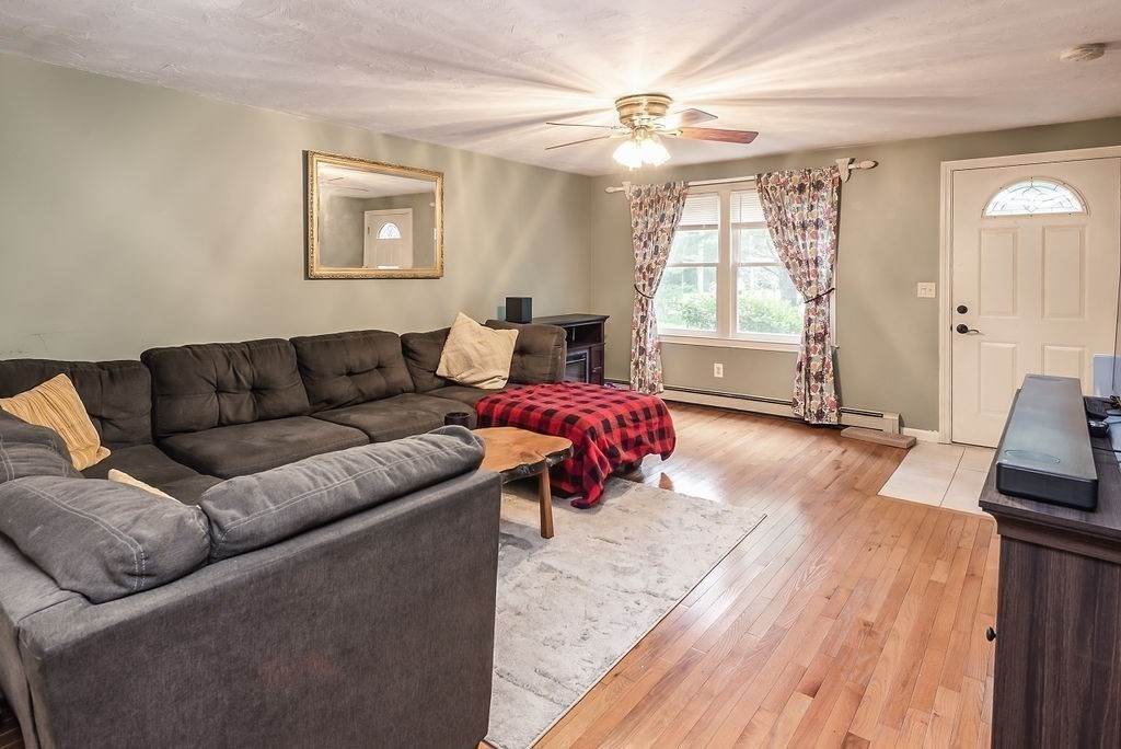 1 Spruce Tree Lane, Unit 3 Norton, MA 02766 - Photo 7 of 18 a living room with furniture and a flat screen tv