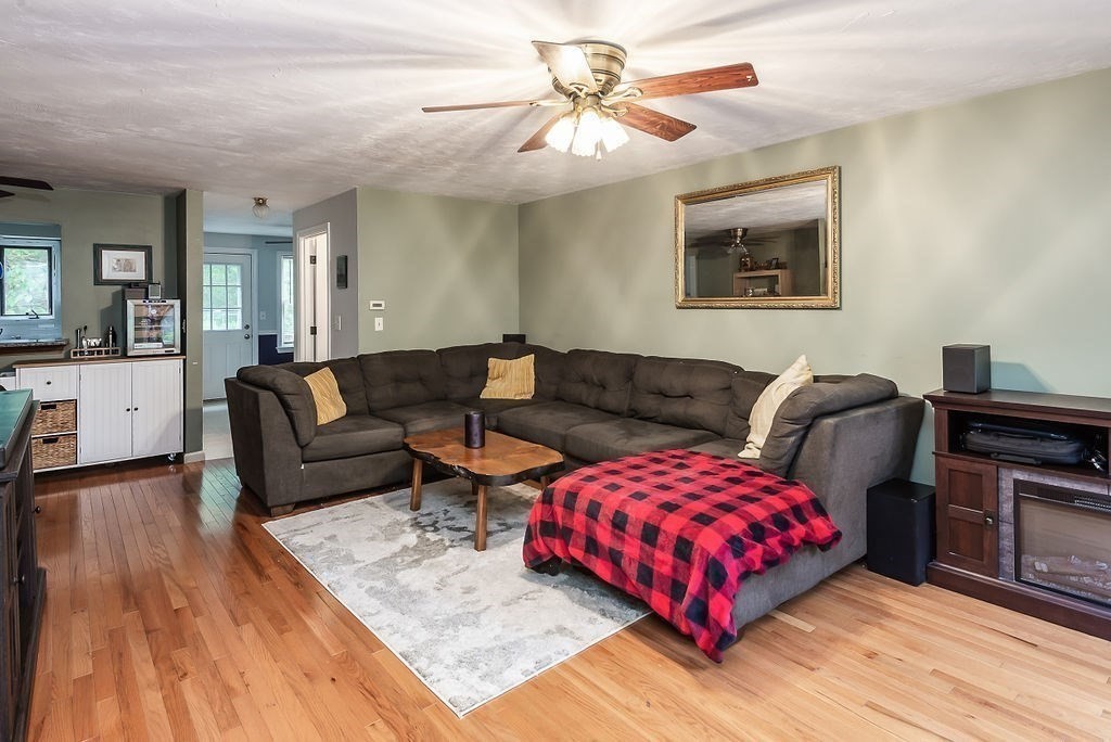 1 Spruce Tree Lane, Unit 3 Norton, MA 02766 - Photo 8 of 18 a living room with furniture ceiling fan and a wooden floor