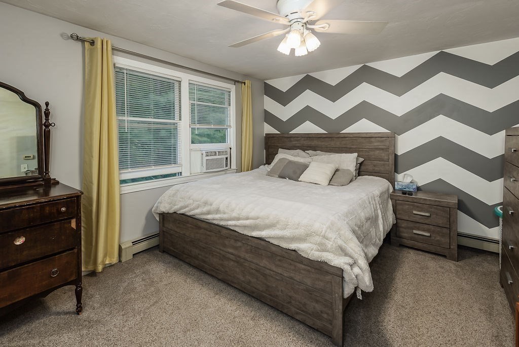 1 Spruce Tree Lane, Unit 3 Norton, MA 02766 - Photo 10 of 18 a bedroom with a bed and a flat tv screen on dresser