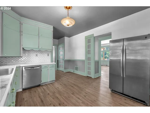 a kitchen with a refrigerator and a sink