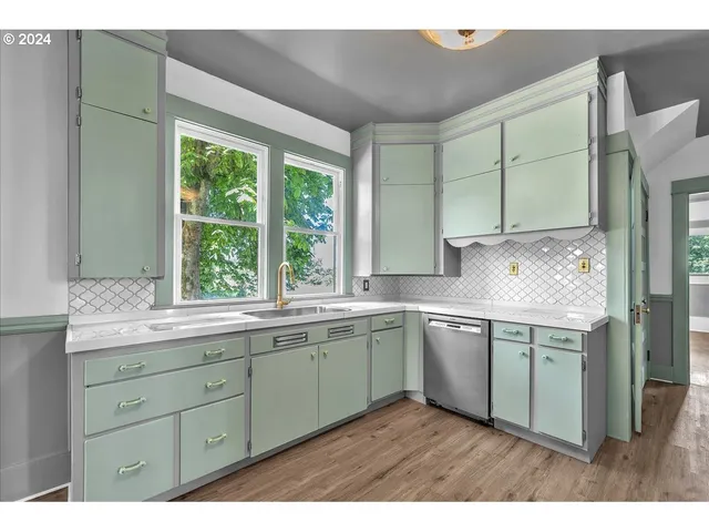 a kitchen with a sink cabinets and window