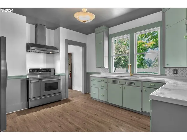 a kitchen with granite countertop a stove and a sink