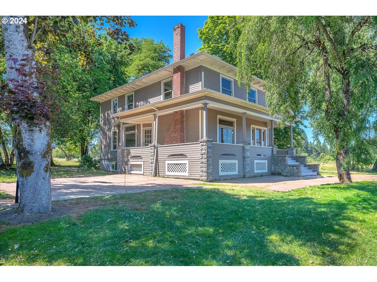 54886 Fullerton Road Scappoose, OR 97056 - Photo 2 of 42 a front view of a house with a yard
