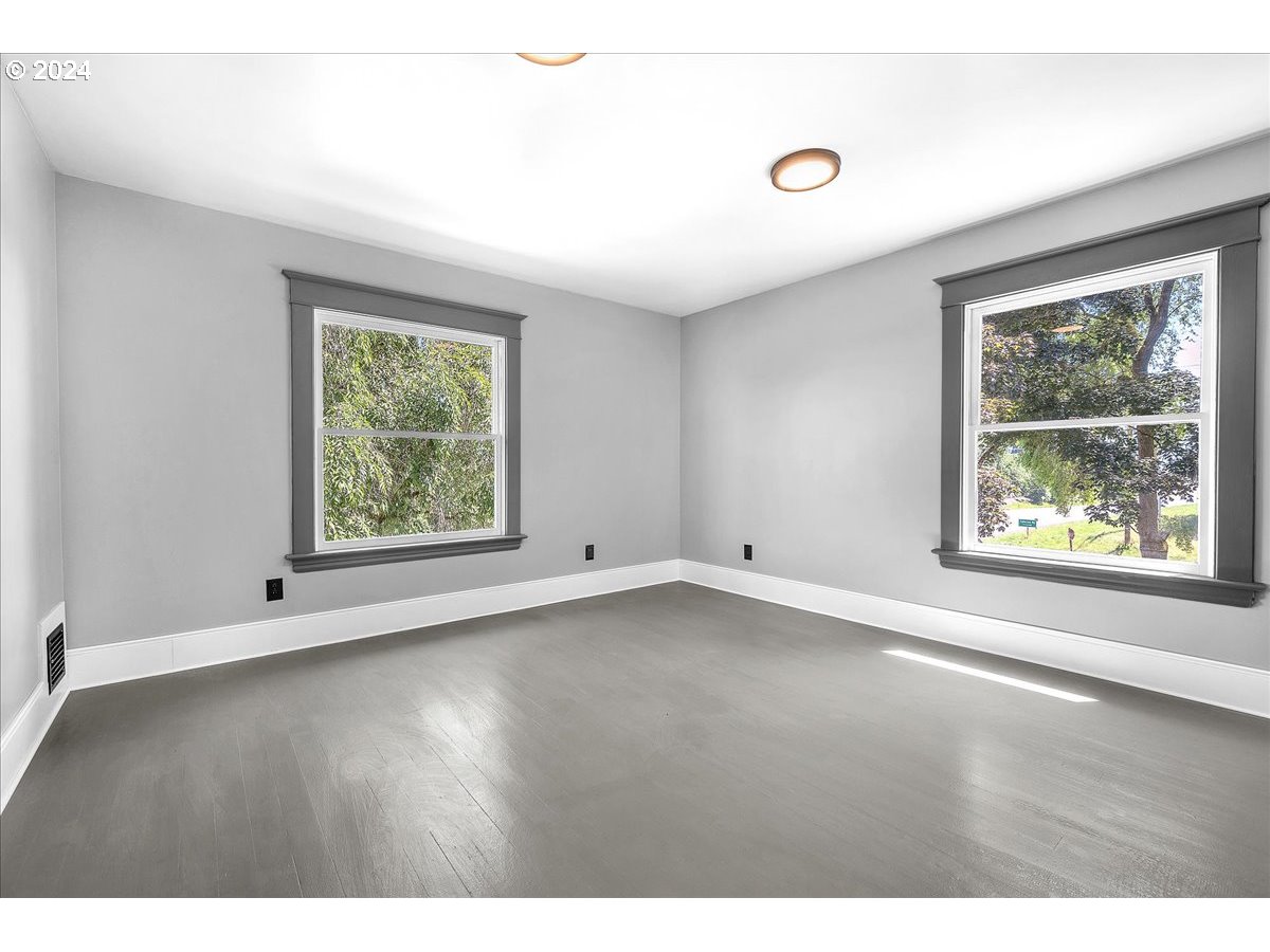 54886 Fullerton Road Scappoose, OR 97056 - Photo 32 of 42 an empty room with wooden floor and windows