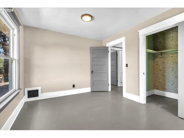 a view of an empty room and wooden floor