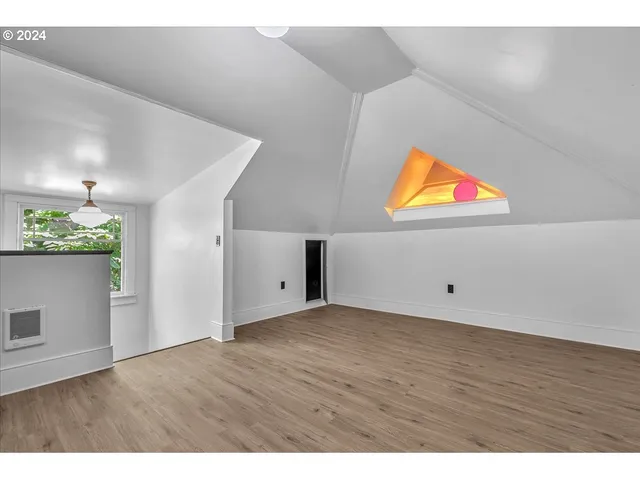 a view of a room with wooden floor