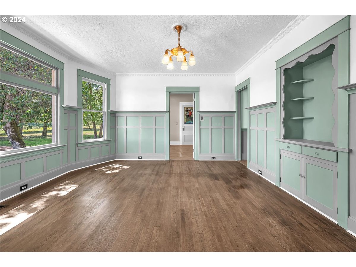 54886 Fullerton Road Scappoose, OR 97056 - Photo 7 of 42 a view of an empty room with painting and a window