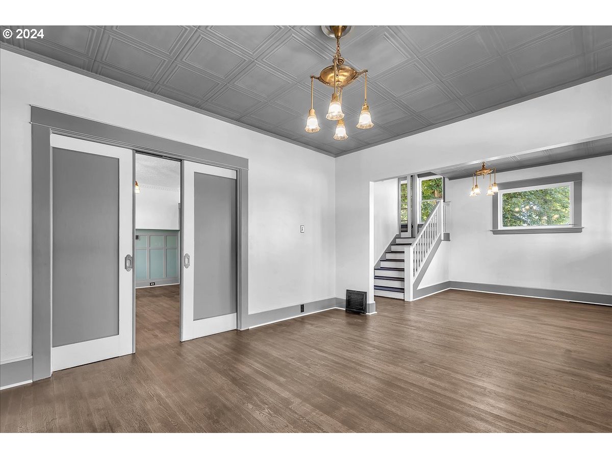 54886 Fullerton Road Scappoose, OR 97056 - Photo 9 of 42 a view of an empty room with a window and wooden floor