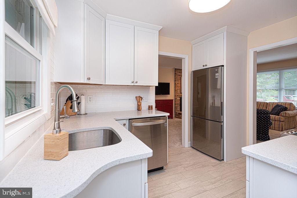 33 Falcon Bridge Road Ocean Pines, MD 21811 - Photo 24 of 71 a kitchen with a refrigerator sink and cabinets