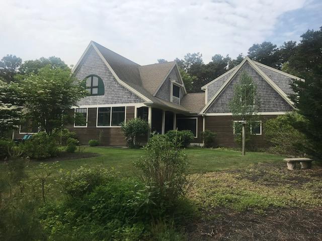 35 Ridge St Extension Wellfleet, MA 02667 - Photo 1 of 24 a front view of a house with a garden