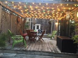 35 Ridge St Extension Wellfleet, MA 02667 - Photo 21 of 24 a view of a patio with table and chairs and potted plants with wooden floor