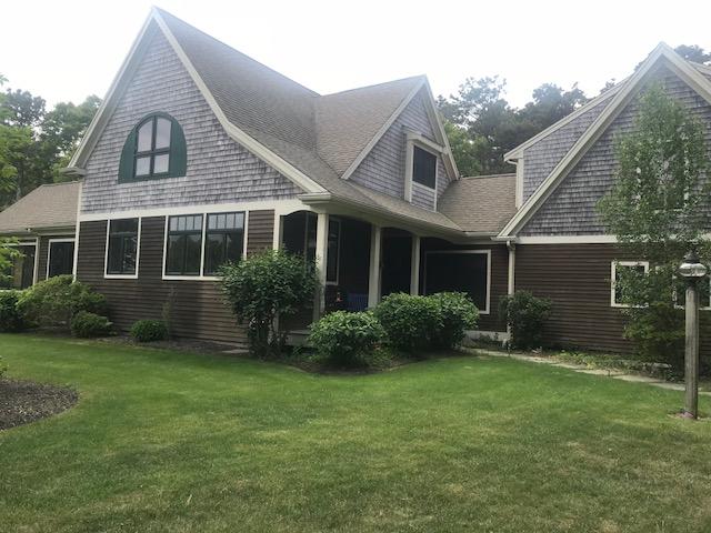 35 Ridge St Extension Wellfleet, MA 02667 - Photo 3 of 24 a view of a yard in front of a house with plants and large tree