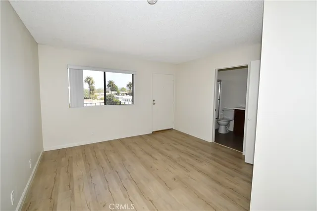 an empty room with windows and closet