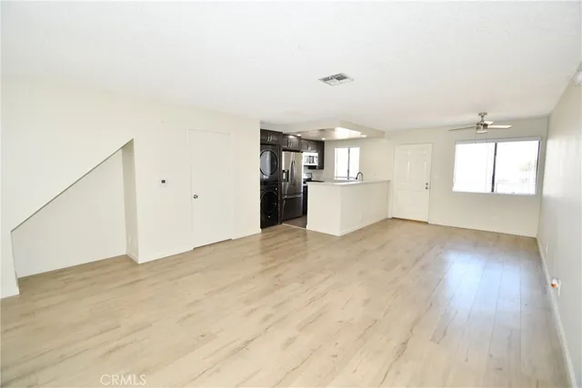 a view of a kitchen with a sink and dishwasher wooden floor