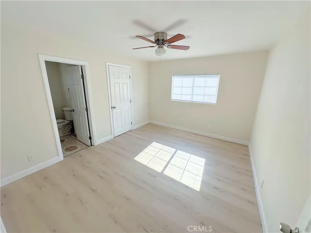an empty room with windows and closet