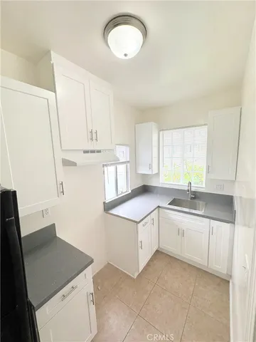 a kitchen with a sink dishwasher a stove and a refrigerator