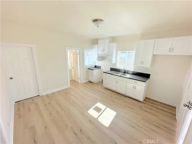a kitchen with a refrigerator and a stove top oven