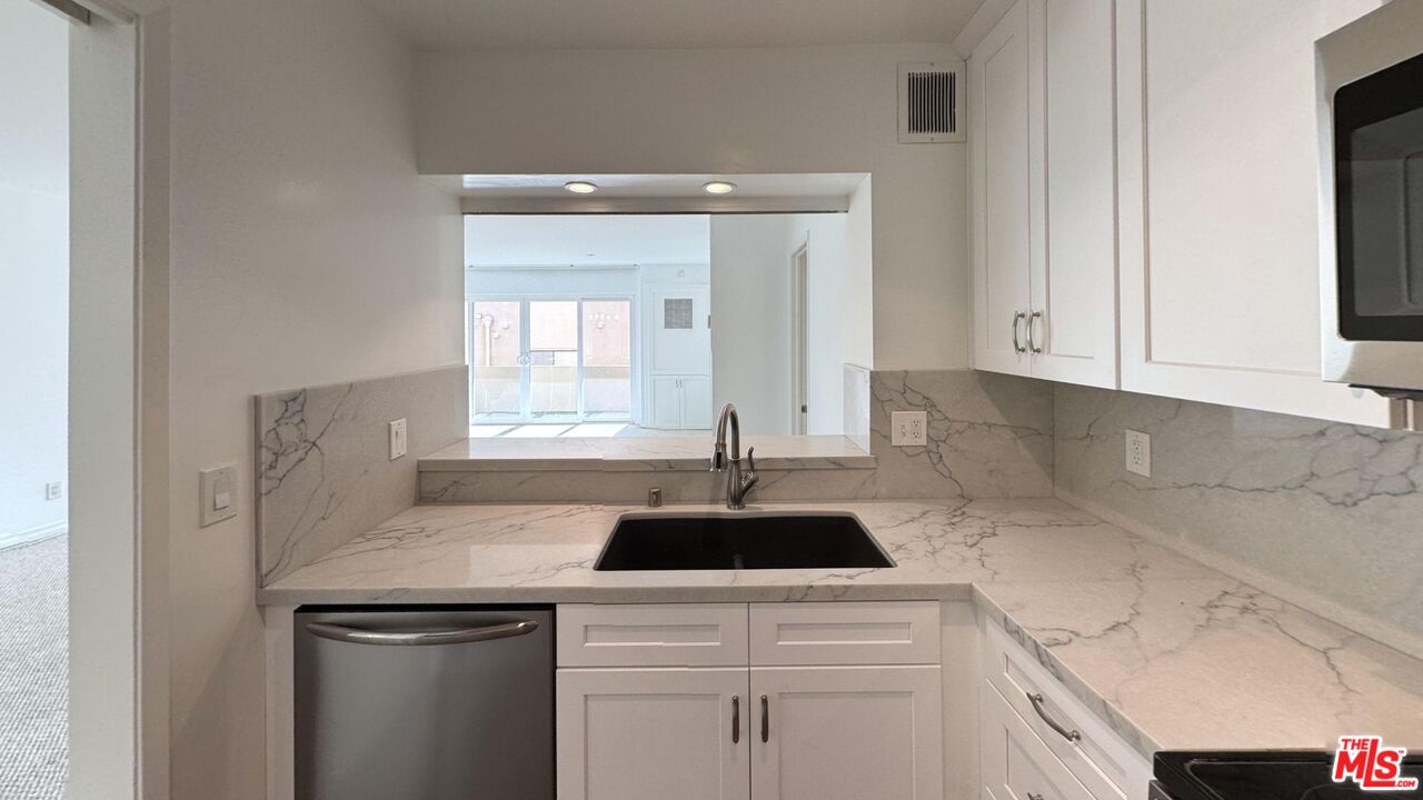 11750 Sunset Boulevard, Unit 317 Los Angeles, CA 90049 - Photo 2 of 11 a kitchen with a sink and cabinets