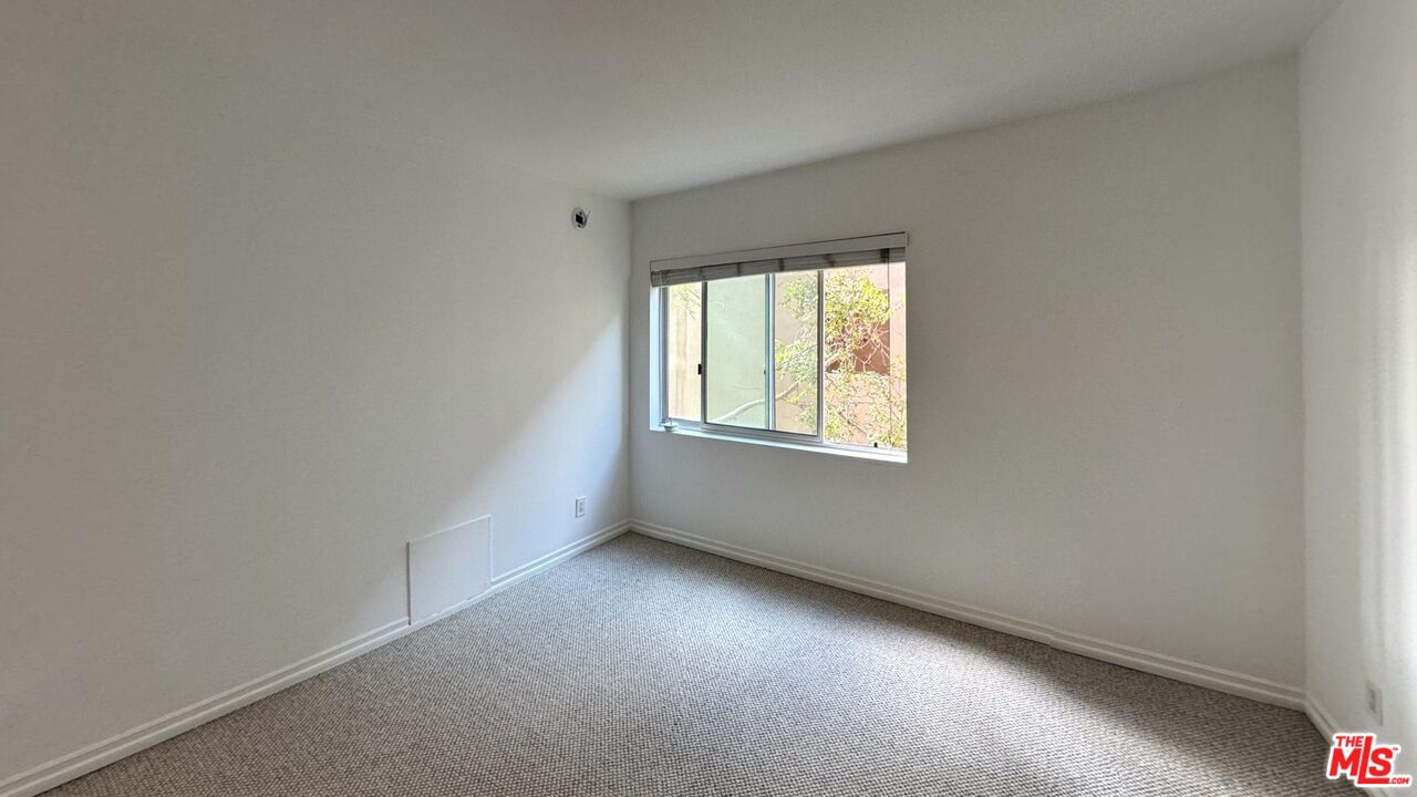11750 Sunset Boulevard, Unit 317 Los Angeles, CA 90049 - Photo 8 of 11 an empty room with a window