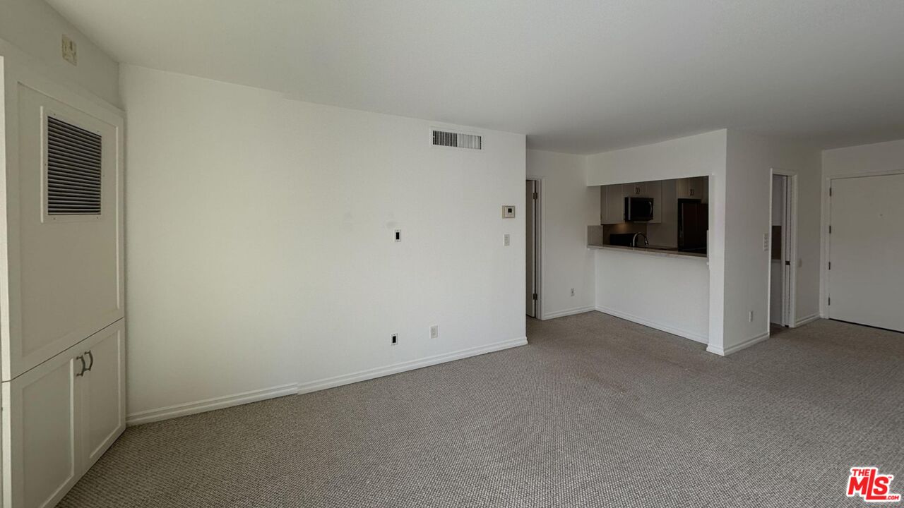 11750 Sunset Boulevard, Unit 317 Los Angeles, CA 90049 - Photo 9 of 11 a view of a livingroom with an empty space and a hallway