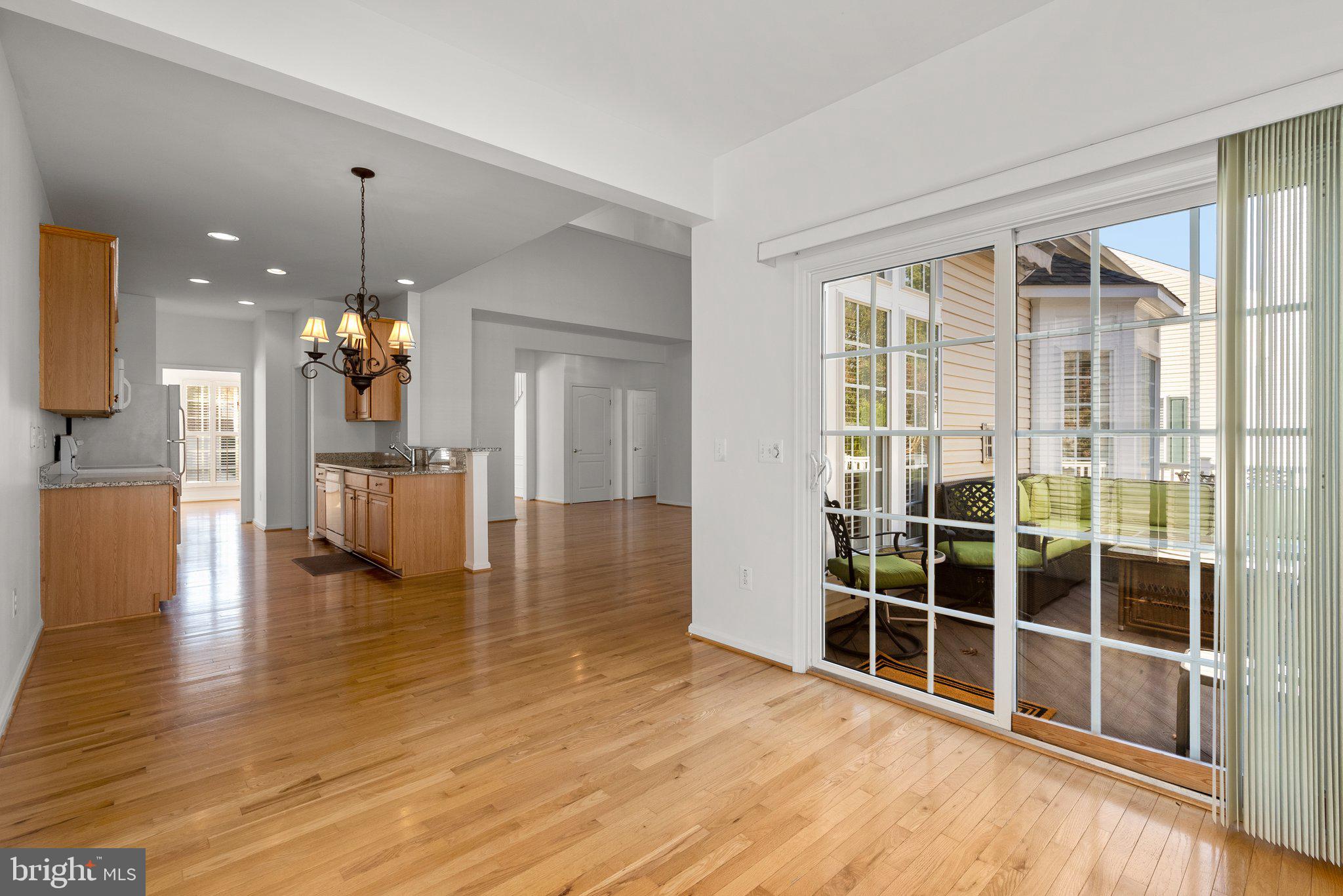 1256 Destiny Circle Annapolis, MD 21409 - Photo 17 of 49 a view of a living room with kitchen island furniture and wooden floor