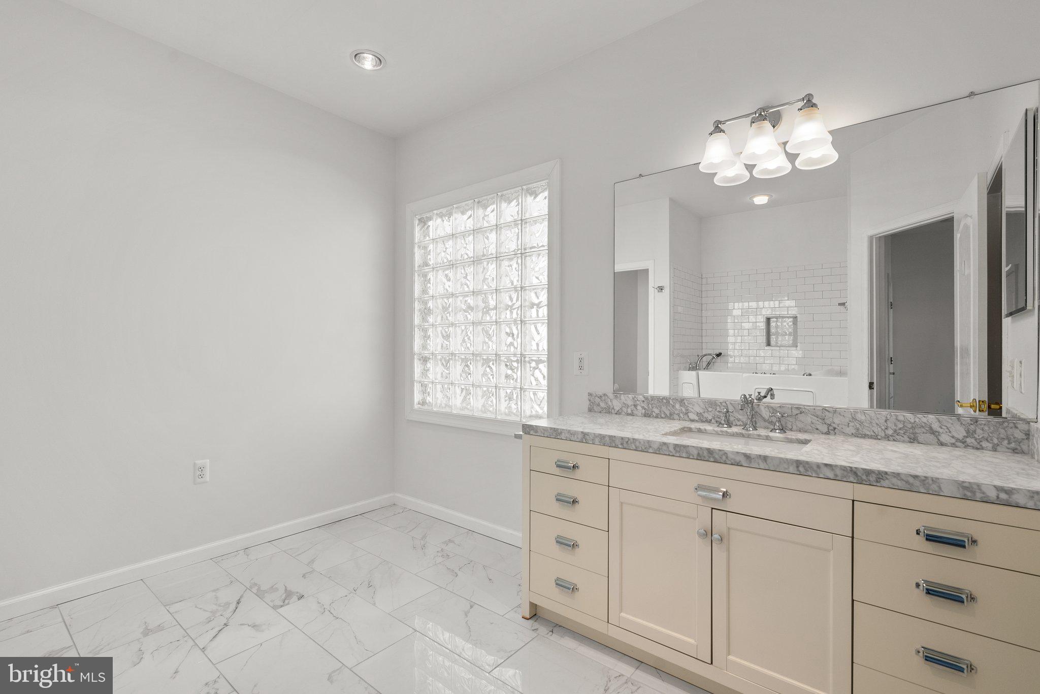 1256 Destiny Circle Annapolis, MD 21409 - Photo 25 of 49 a bathroom with a double vanity sink and a mirror