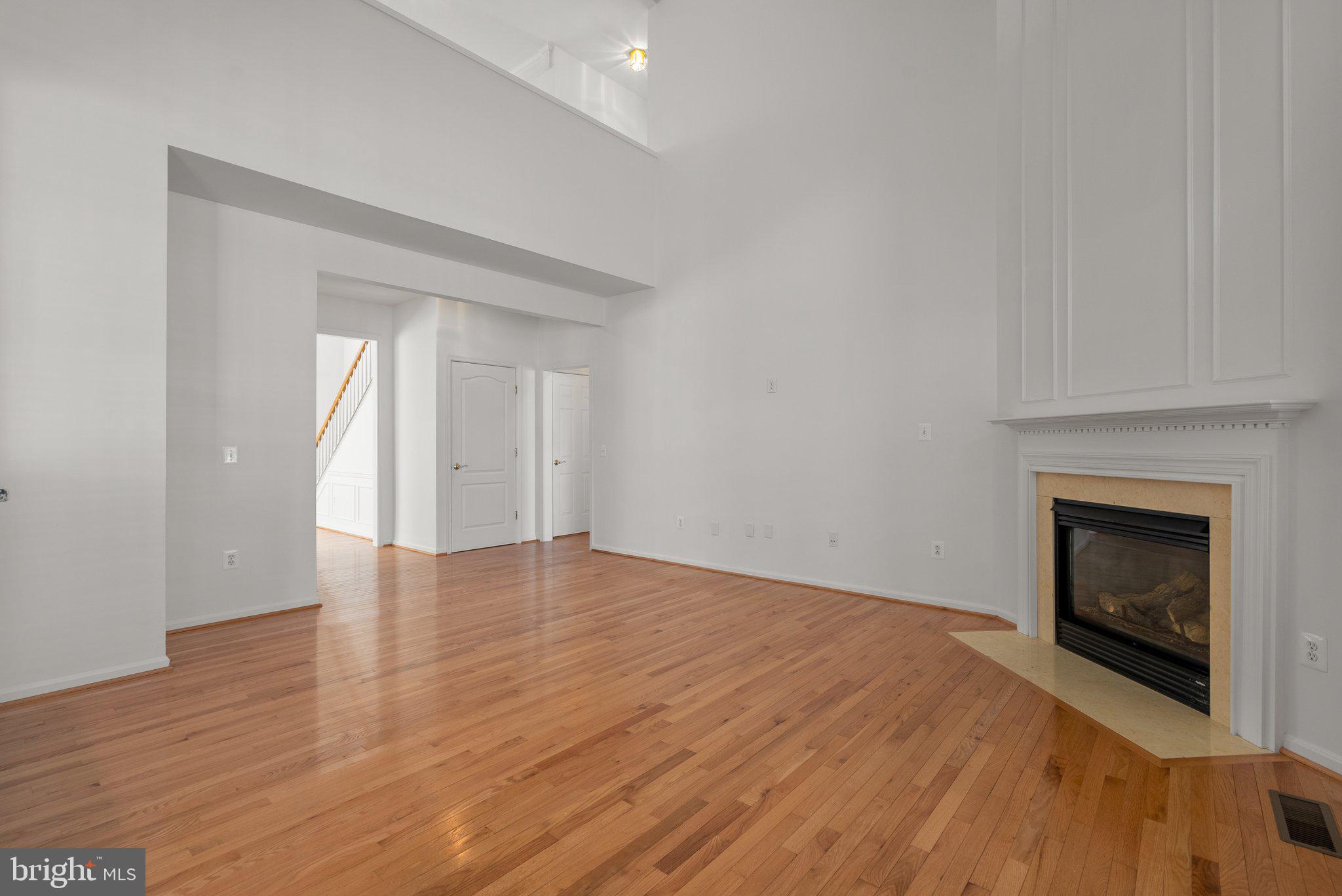 1256 Destiny Circle Annapolis, MD 21409 - Photo 7 of 49 a view of an empty room with wooden floor fireplace and a window