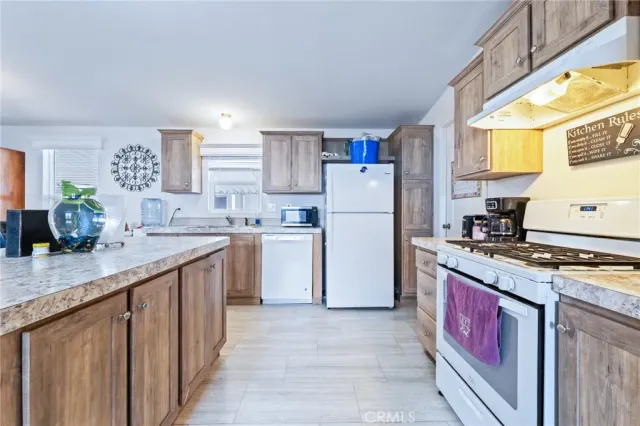 a kitchen with a sink stove and refrigerator