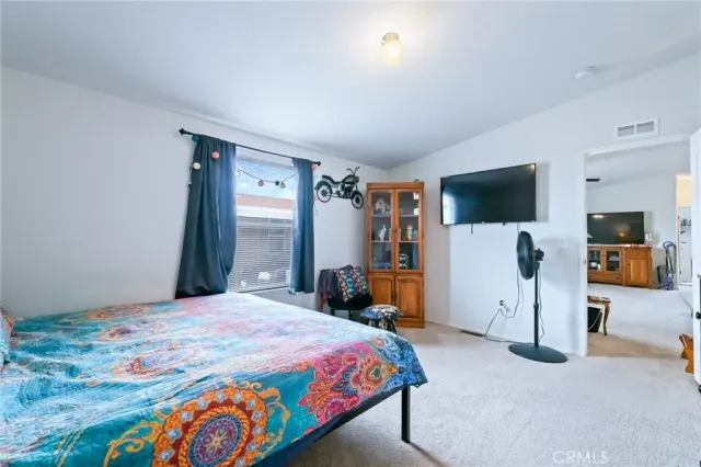 a bedroom with a bed and book shelf