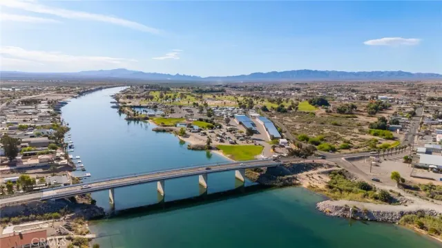 an aerial view of residential houses with outdoor space and ocean view