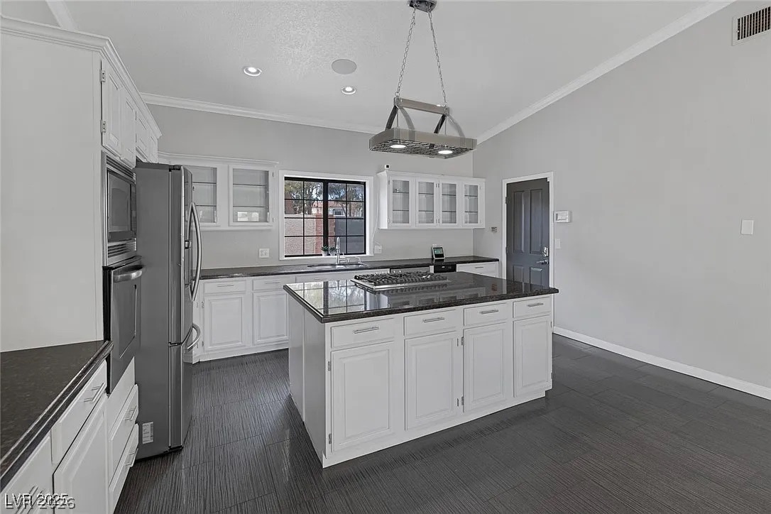 9 Quail Run Road Henderson, NV 89014 - Photo 19 of 57 An inviting kitchen with vaulted ceilings, a central island, and modern stainless steel appliances.