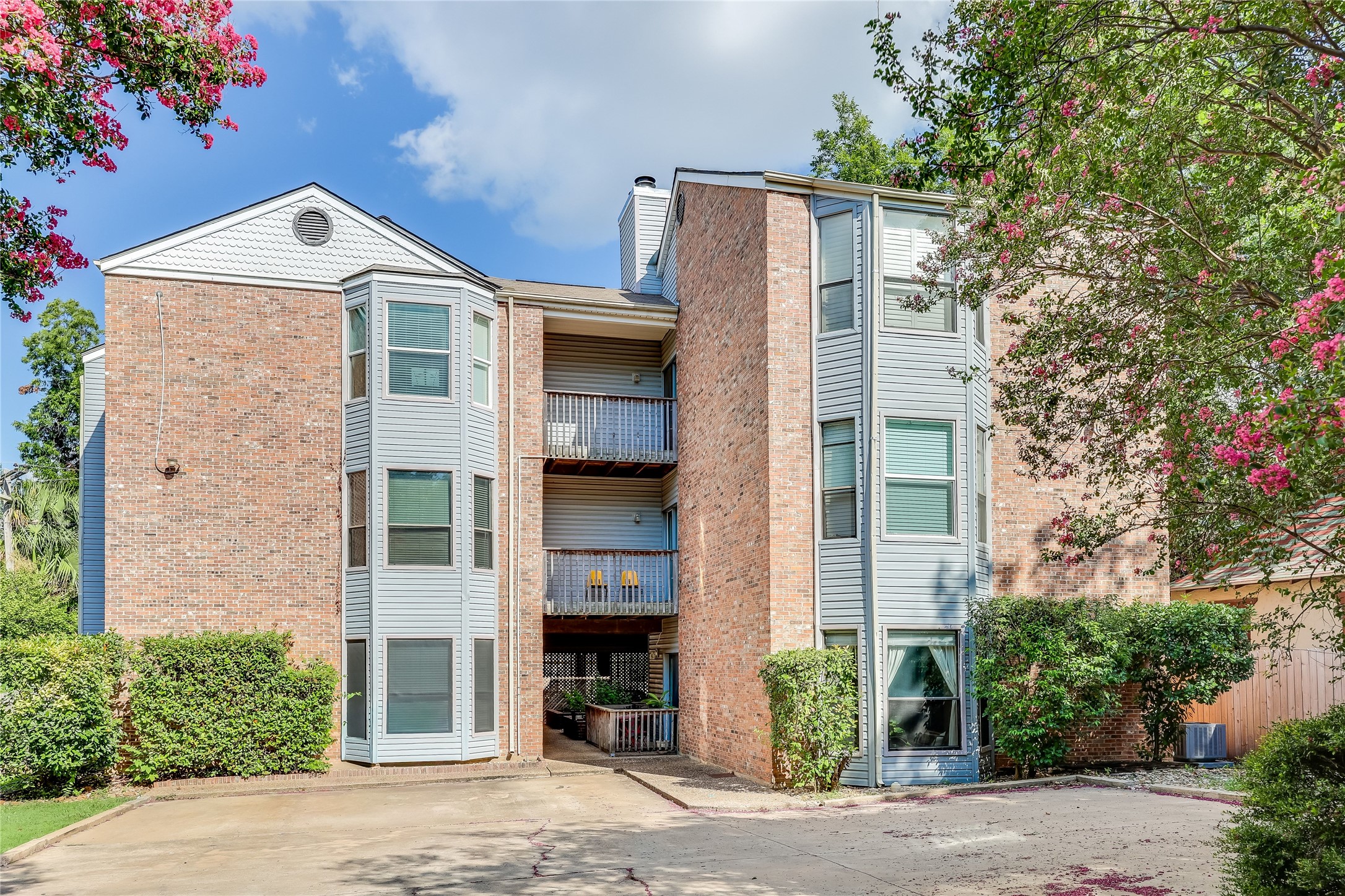 3011 Fruth Street, Unit 101 Austin, TX 78705 - Photo 1 of 14 Multi-story brick and siding structure with multiple private balconies.