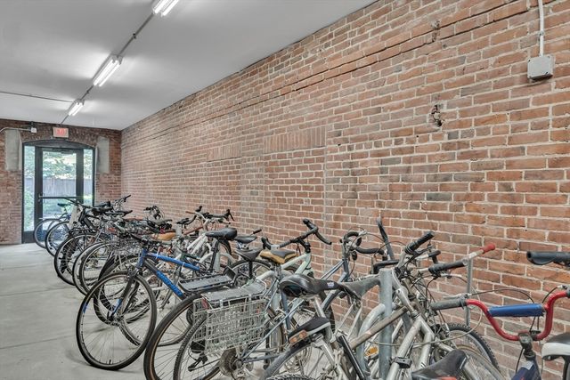 a view of a patio with table and chairs potted plants and large tree