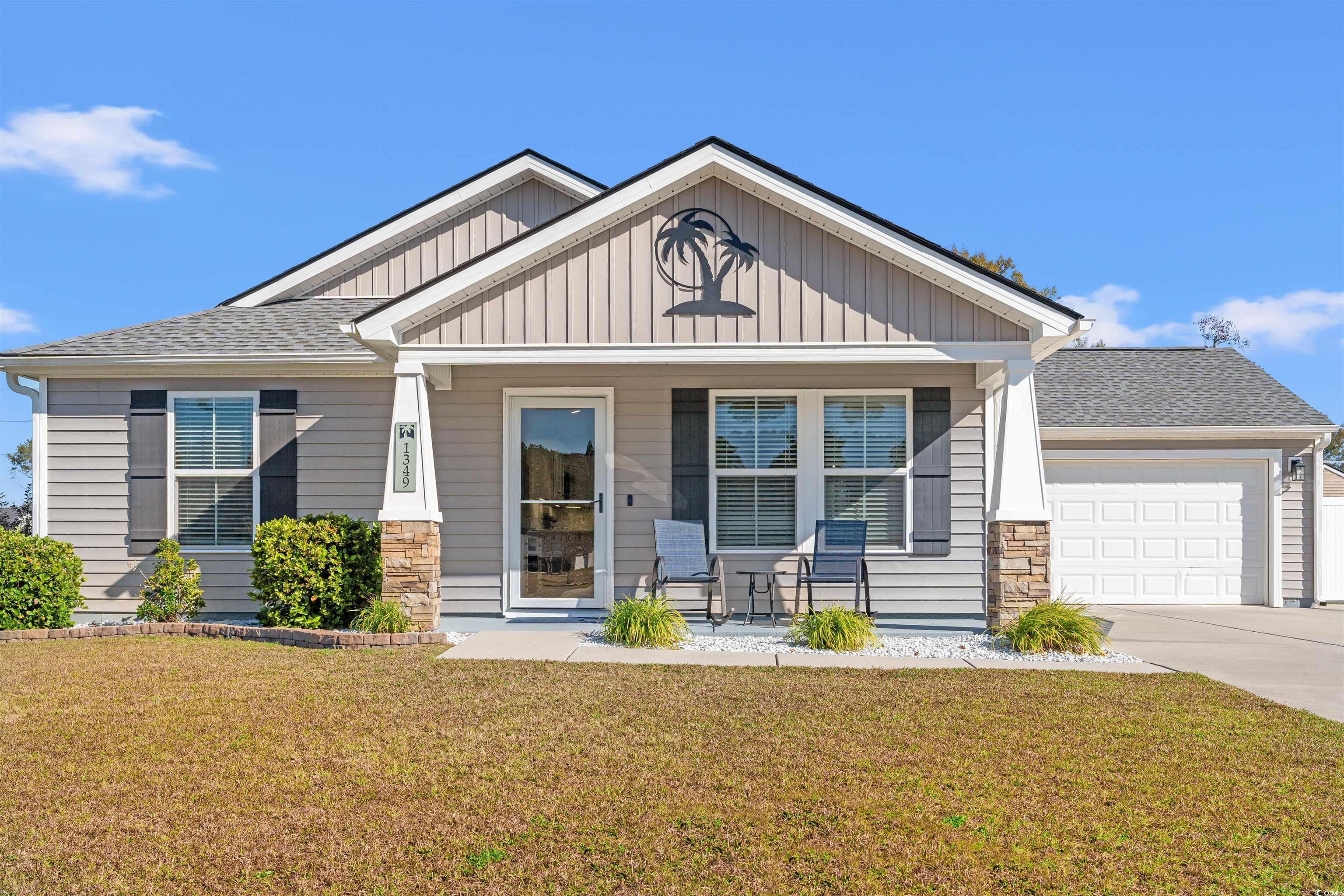 1349 Boker Road Conway, SC 29527 - Photo 1 of 21 Craftsman-style house featuring covered porch, roof with shingles, a front lawn, and board and batten siding