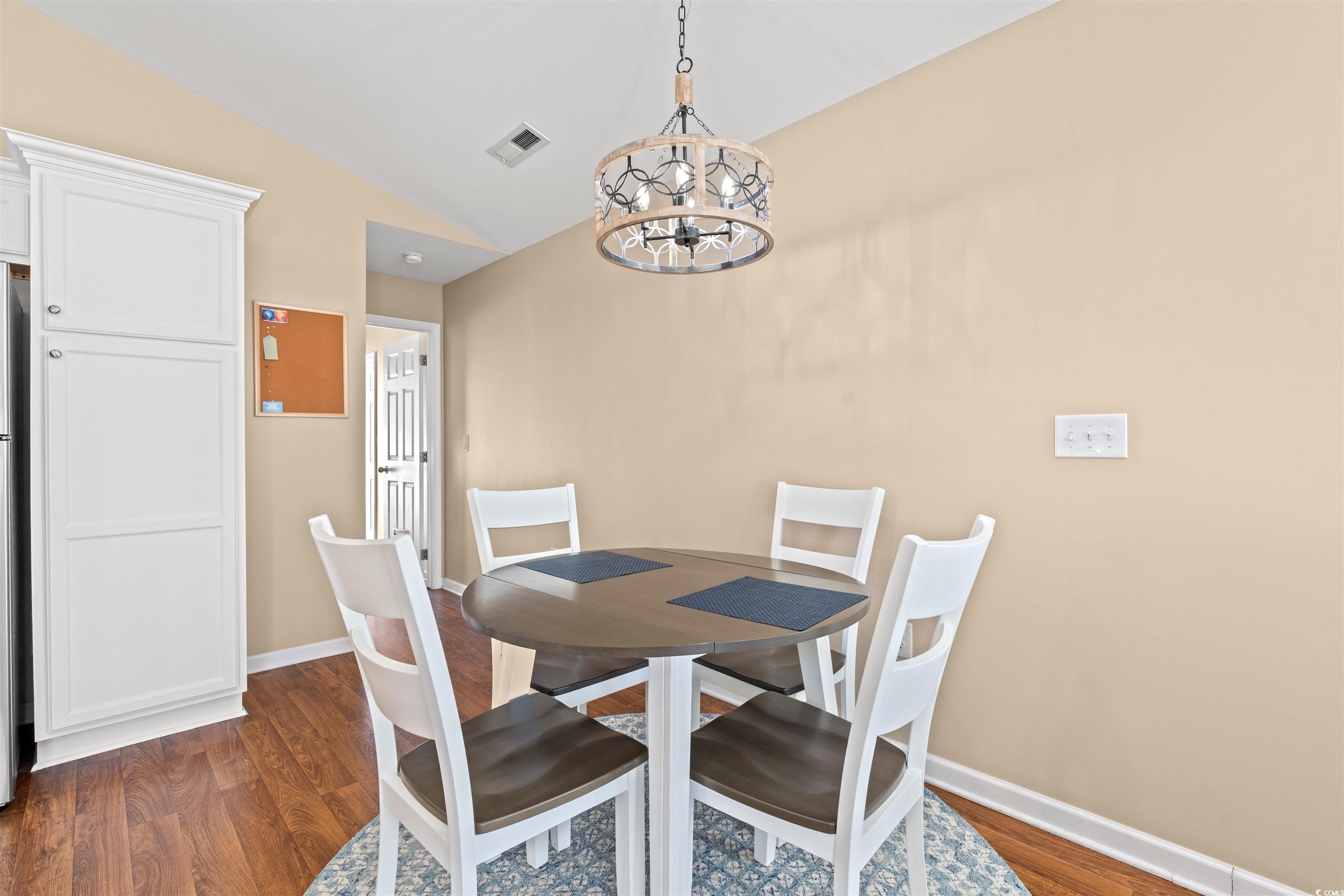 1349 Boker Road Conway, SC 29527 - Photo 3 of 21 Dining room featuring dark wood-style flooring, lofted ceiling, and a chandelier