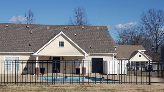 a swimming pool with outdoor seating and yard