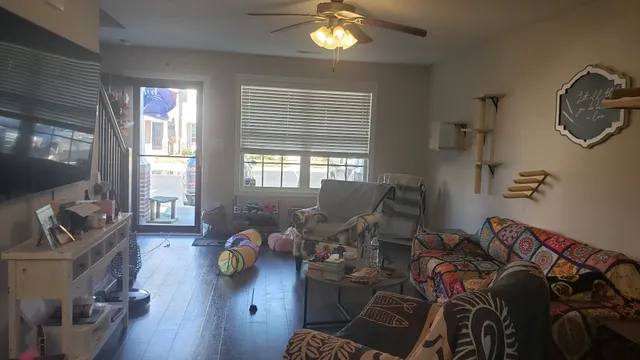 a living room with furniture and wooden floor