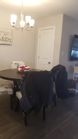 a bedroom with a bed table and chair