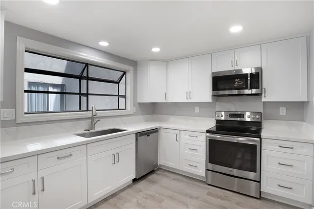 a kitchen with a sink and a stove top oven