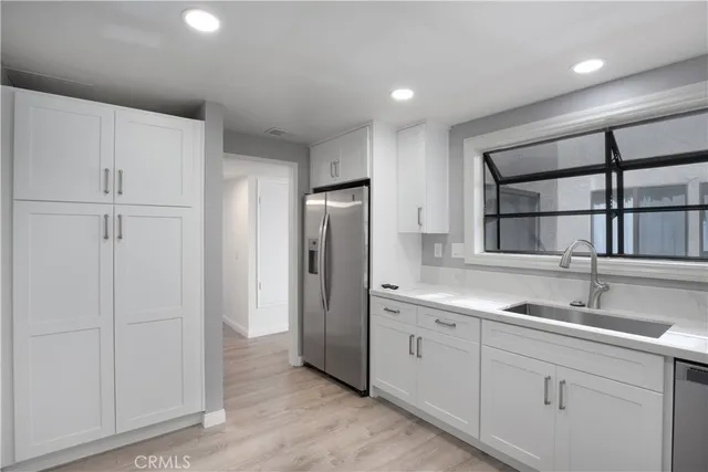 a kitchen with a sink and refrigerator
