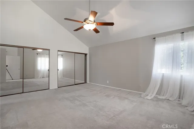 an empty room with fan and entrance