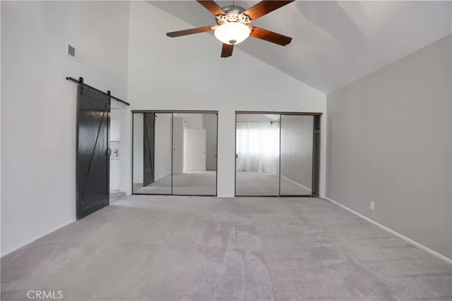 a view of an empty room with a ceiling fan