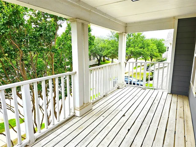 a view of balcony with wooden floor