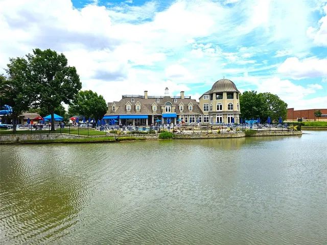 a view of an ocean with boats and trees in the background